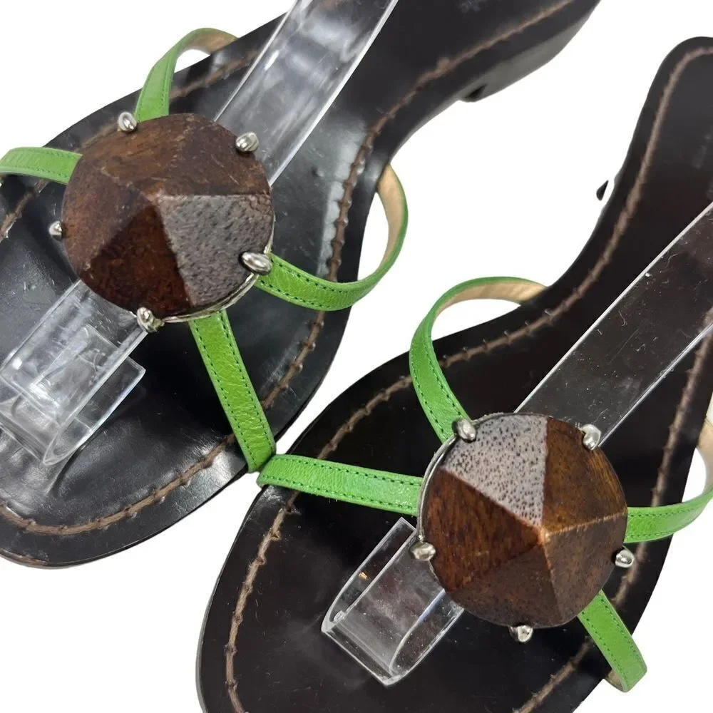 Kate Spade Green Leather Flat Sandals with wooden center ornament.